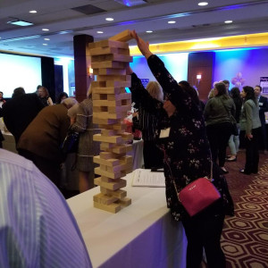 a group of people playing a game of giant blocks