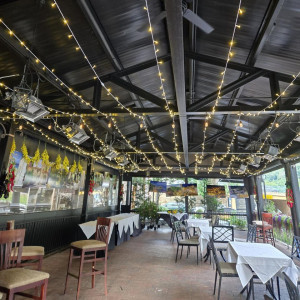 the inside of a restaurant with tables and chairs
