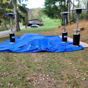a blue tarp covering the ground in a park