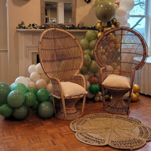 a room filled with balloons and wicker chairs