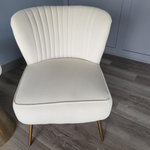 a pair of white chairs sitting on top of a wooden floor