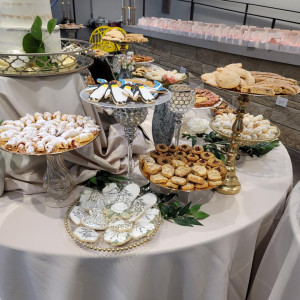 a table topped with lots of desserts and pastries