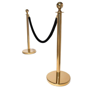 a pair of gold metal poles with a black rope