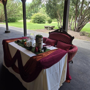 Crimson Heirloom Settee in deep burgundy and gold upholstery with carved dark wood frame styled at Succop Nature Park for a luxury wedding sweetheart table in Pittsburgh PA