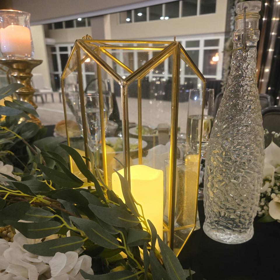 Gold hexagon terrarium lantern with glass panels and candlelight styled on an elegant wedding reception table in Pittsburgh
