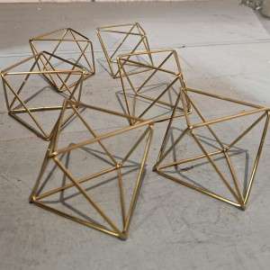 Gold diamond geometric terrarium décor accents arranged on a neutral surface for modern wedding table styling in Pittsburgh