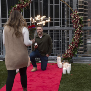 a man and a woman standing on a red carpet