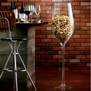 a wine glass filled with wine next to a table