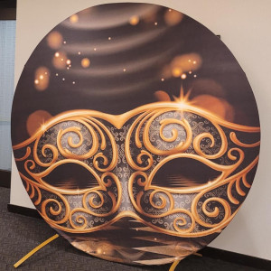 Gold Masquerade Spandex Backdrop Cover on The Luna Gold Round Arch, dramatic Venetian gold masquerade mask design in deep mocha and gold bokeh for galas, masquerade parties, and luxury events in Pittsburgh PA, Event Rentals of Pittsburgh