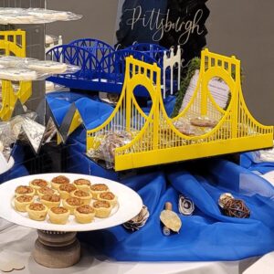 Three Sisters Bridge 3D printed yellow suspension bridge cookie table rental representing Roberto Clemente Andy Warhol and Rachel Carson bridges for Pittsburgh wedding cookie tables, Event Rentals of Pittsburgh
